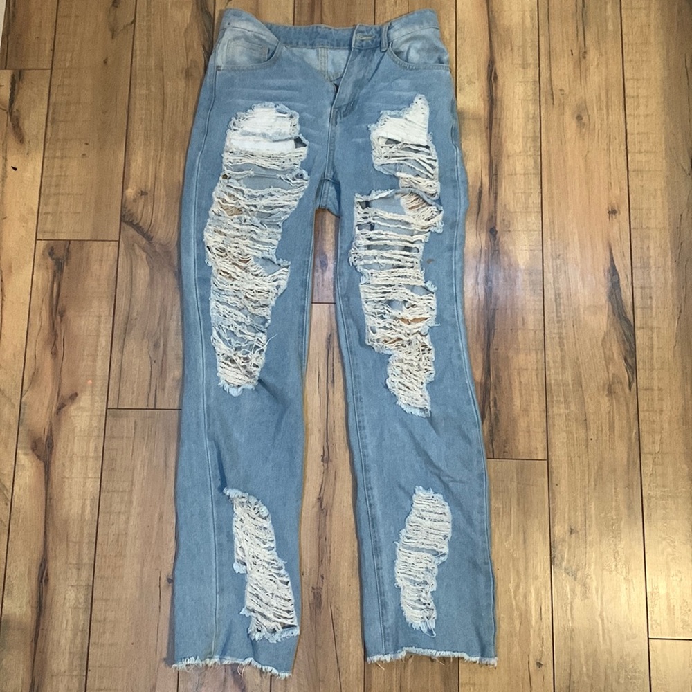 Straight legged ripped blue jeans